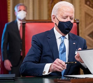 President Biden signing exective orders. Source - www.rnz.co.nz