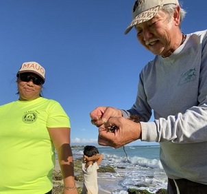 Image - Kim Moa/KUA. Limu Hui coordinator Wally Ito shows some limu to participants of the organization’s regular limu walks in Hawai‘i, which help locals connect with local seaweed species. Image by Kim Moa/KUA.