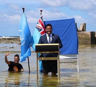 Tuvalu’s Minister for Justice, Communication & Foreign Affairs Simon Kofe gives a COP26 statement while standing in the ocean in Funafuti, Tuvalu November 5, 2021. Tuvalu Foreign Ministry | via Reuters Tuvalu’s Minister for Justice, Communication & Foreign Affairs Simon Kofe gives a COP26 statement while standing in the ocean in Funafuti, Tuvalu November 5, 2021. Tuvalu Foreign Ministry | via Reuters