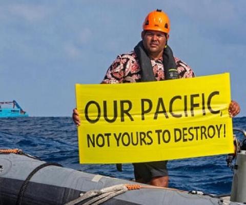 Victor Pickering, a Greenpeace activist from Fiji, in front of the Maersk Launcher, a ship chartered by DeepGreen. Photo: Supplied / Greenpeace