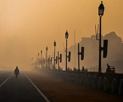 A man walks along Rajpath amid smoggy conditions in New Delhi on January 28, 2021. (Jewel Samad/AFP via Getty Images)