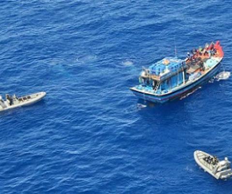A Vietnamese illegal fishing vessel in the Coral Sea being intercepted by Australian Border Force. AAP Image/Department of Immigration and Border Protection