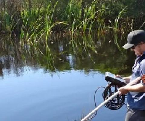A NSW environment officer collects data at Bengello near Batemans Bay. Water in estuaries has warmed at a much faster rate than the atmosphere or oceans, a study has found. Photograph: New South Wales Department of Planning, Industry and Environment