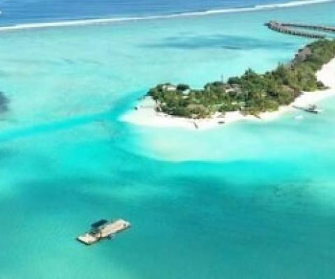In the lower left corner of this photograph, researchers prepare a submersible device. “Together with our collaborators in the Maldives, we are designing, testing, building, and deploying submersible devices that, based simply on their geometry in relationship to the ocean waves and currents, promote sand accumulation in specific areas,” says associate professor Skylar Tibbits. Credit: Massachusetts Institute of Technology
