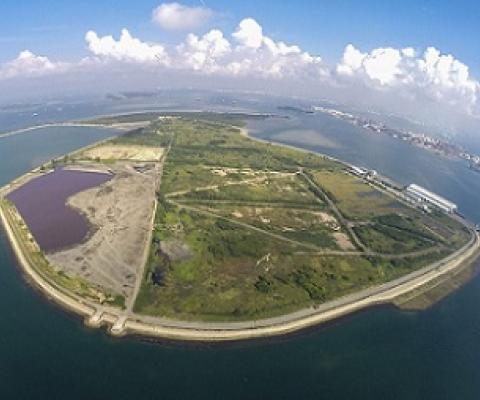 An aerial view of Semaku landfill that was created by filling in part of the sea between two of Singapore’s offshore islands, Pulau Se-makau and Pulau Sakeng. Credit - Island Nation.