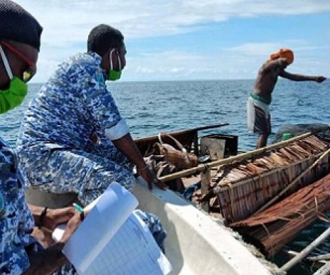 Patrolmen document a violation in a marine reserve in West Papua. Image: Syafri Tuharea, UTPD