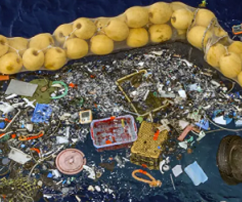 The boom skims up waste ranging in size from a discarded net and a car wheel to tiny chips of plastic. Photo credit: AP