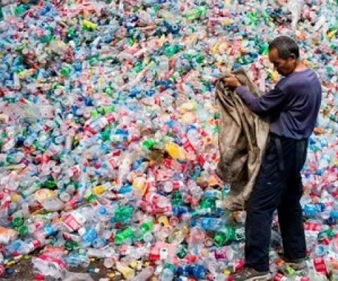 A Chinese labourer sorting out plastic bottles on the outskirt of Beijing. Photograph: Fred Dufour/AFP/Getty Images