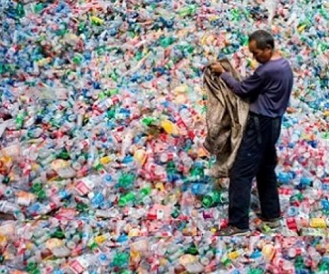 A Chinese labourer sorting out plastic bottles on the outskirt of Beijing. Photograph: Fred Dufour/AFP/Getty Images