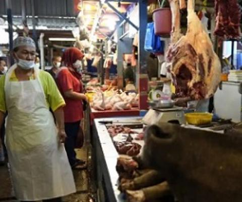 A poultry butcher at a wet market in Kuala Lumpur. Photograph: Vincent Thian/AP